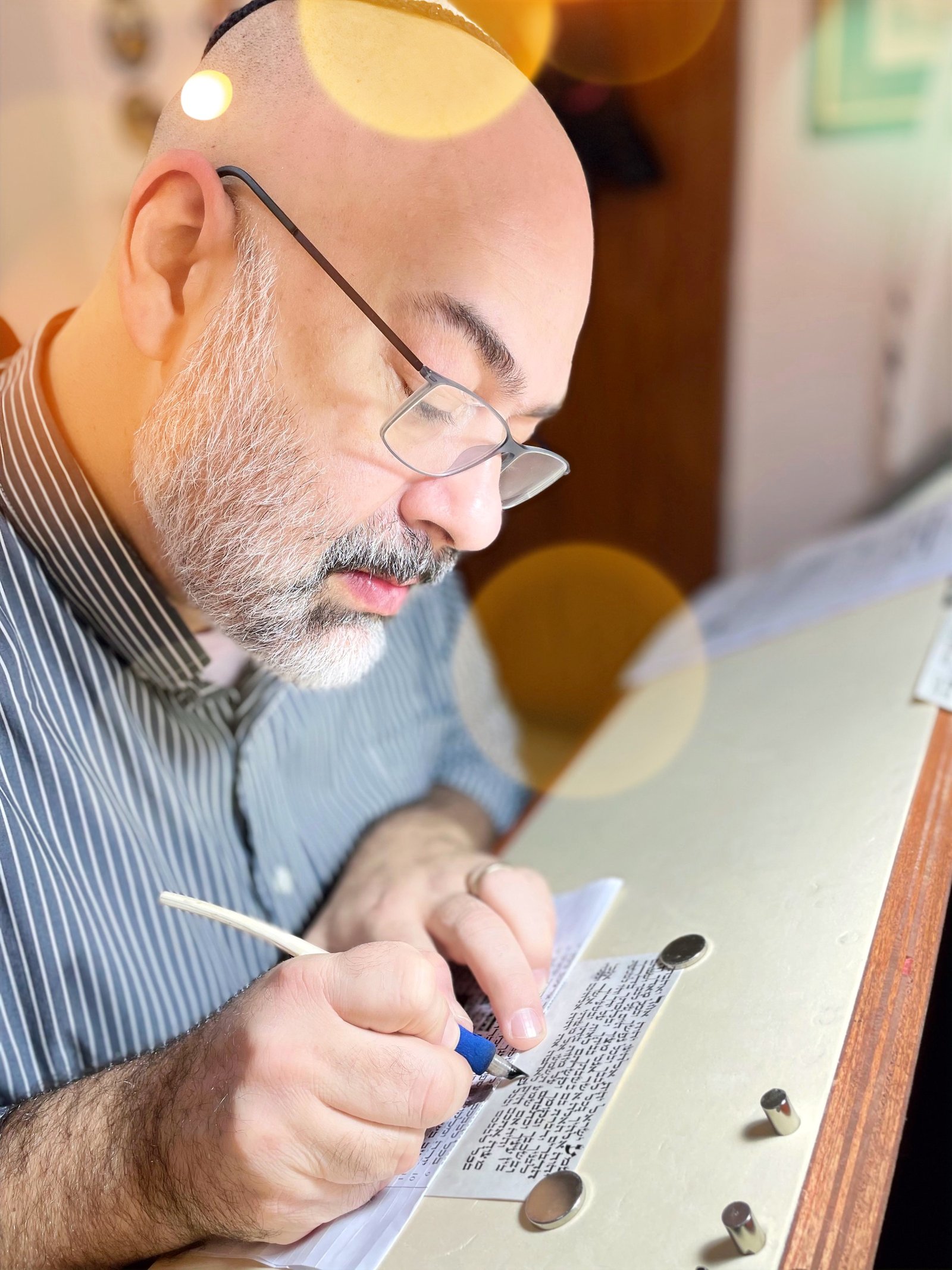 Sofer writing with a quill